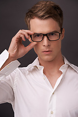 Image showing Serious, nerd and portrait of man with glasses, fashion or eyewear in dark background of studio. Optometry, healthcare and geek with spectacles, style and person with prescription lenses in frame