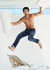 Image showing Portrait, bed and jump with a shirtless man in his home for freedom, energy or fun on a weekend morning. Bedroom, excitement and the body of a masculine young person leaping in his apartment