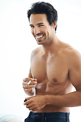 Image showing Smile, cigarette and a shirtless man smoking in studio on a white background for nicotine addiction. Smoke, tobacco and body with a happy young person in the bedroom of his home to relax for leisure