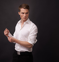 Image showing Fashion, studio man and thinking of fancy clothes for semi formal outfit, attire or confident in classy, elegant or stylish apparel. Fix dress shirt, mockup space or model choice on black background