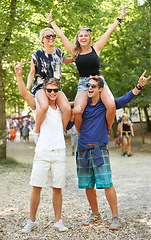 Image showing Couple, man and carrying woman on shoulders at music festival with cheers for celebration in woods. Happy, people or rock n roll portrait at social, event or men support girlfriends for fun and games