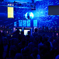 Image showing People, crowd and dancing in nightclub or party with lightning, disco ball and music for entertainment. Event, festival or rave on dance floor with energy, group and performance for nightlife or club