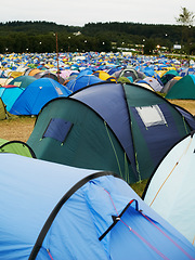 Image showing Tent, field and outdoor for music festival or camping in nature, summer or forest for adventure or vacation. Event, campsite or setup for sleeping, rest or shelter in woods, trees or environment
