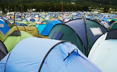 Image showing Tent, field and outdoor for festival or camping in nature, summer or forest for adventure or vacation. Event, campsite or setup for sleeping, rest or shelter in woods, trees or environment background