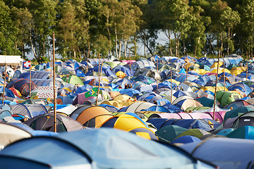 Image showing Camping, tents and outdoor music festival in park, field with trees or forest in summer. Camp, site and shelter at party, event or adventure with travel in woods for concert, rave and carnival