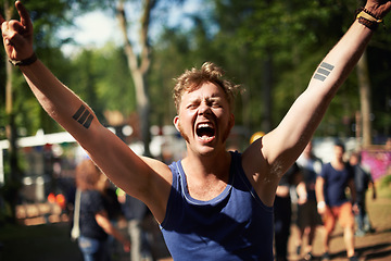 Image showing Excited, cheers and man at music festival with nature, smile and fan in forest for concert event. Relax, happy celebration at outdoor party with freedom and adventure, person with trees and scream.