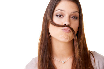 Image showing Funny, portrait and woman with hair as a mustache in studio, white background or model with confidence. Person, pouting and posing with hairstyle, beauty or silly girl with crazy expression or face