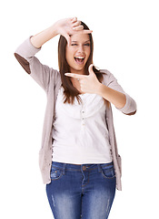 Image showing Portrait, hands and woman with selfie frame in studio for photography, gesture or sign on white background. Finger, border and person face with emoji wink for social media, profile picture or memory