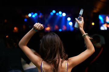 Image showing Woman, back and dancing at night festival, party or music concert for DJ, performance or sound. Rear view of female person enjoying late evening entertainment at outdoor carnival, rave or audio event