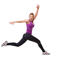 Image showing Woman, winner and jump for fitness success, workout and training celebration, energy or achievement in studio. Portrait of sports model or runner in air for exercise and cardio on a white background