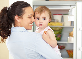 Image showing Happy woman, toddler and face in kitchen, fridge and food for eating, hunger or snack. Mother, little girl and fruit for nutrition, yummy and delicious for vegetarian, healthy and diet in home