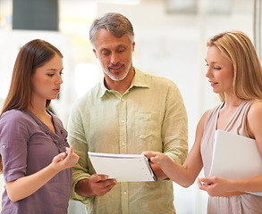 Image showing Business people, manager and collaboration with documents for advice, reading proposal and marketing project. Creative employees, boss and women with paperwork, teamwork or planning of startup report