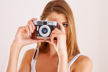 Image showing Photography, woman and retro camera in studio for content creation, magazine photoshoot and paparazzi on white background. Portrait, media and creative photographer with lens for art, skills or hobby