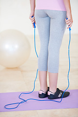 Image showing Woman, skipping rope and exercise for mat cardio or progress training, workout for health fitness. Female person, sports for gym jumping or active lose weight for strong wellbeing, muscle or balance