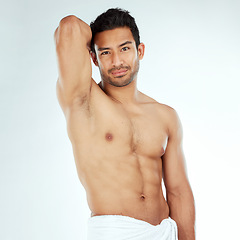 Image showing Shower, towel and portrait of fitness man in studio for cleaning, wellness or cosmetics on white background. Bathroom, body and face of Japanese model with smooth skin, satisfaction or luxury pamper