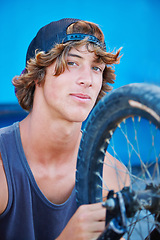 Image showing Bicycle, tire and portrait of man outdoor at skatepark in summer with maintenance, repair or inspection. Bike, care and person fixing wheel or cyclist check air in tyre for performance in cycling