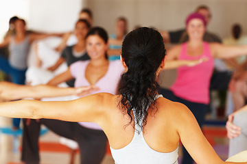 Image showing Back, stretching and yoga class with an instructor in a studio for health, wellness or holistic training. Fitness, exercise and a yogi teaching a student group about zen, balance or inner peace