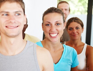 Image showing Portrait, yoga or pilates and woman with a group of people in a studio for health, wellness or mindfulness. Exercise, workout and fitness with happy young friends in gym class for holistic training