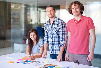 Image showing Portrait, smile and team of business people at table in meeting together, cooperation or collaboration in startup. Happy face, creative group and designers at desk, coworking and solidarity in office