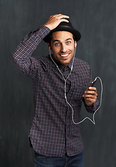 Image showing Man, portrait and cellphone or earphones for music listening in studio entertainment, streaming or black background. Male person, face and hipster fashion or online indie playlist, radio or mockup