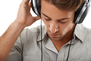 Image showing Man, headphones and listening to calm music in studio for audio subscription, streaming multimedia and radio on white background. Face, model and hearing peaceful podcast, sound and relax for song