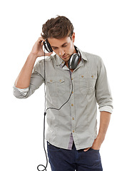 Image showing Man, headphones and music in studio for audio subscription, streaming multimedia and radio on white background. Cool guy listening to podcast, hearing sound and relax for song, entertainment or album