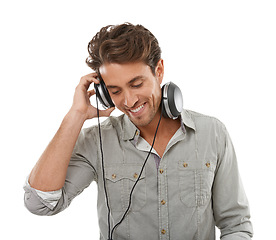 Image showing Man, headphones and smile in studio for music, audio subscription or streaming multimedia on white background. Happy guy listening to podcast, hearing sound and radio for song, entertainment or album