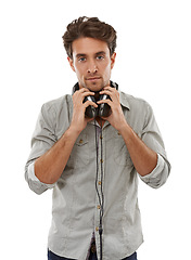 Image showing Man, portrait and headphones around neck in studio for audio subscription, streaming multimedia and radio on white background. Model listening to podcast, hearing sound and music playlist of album