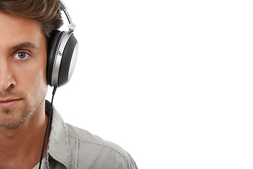 Image showing Headphones, man and face portrait with space in studio for music subscription, streaming multimedia and radio on white background. Serious model listening to podcast, hearing sound or audio on mockup
