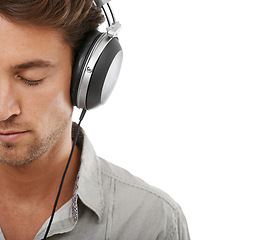 Image showing Calm man, face and space with headphones in studio for audio subscription, streaming multimedia and radio on white background. Model listening to peaceful podcast, hearing sound and music with mockup