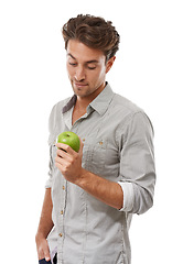 Image showing Healthy diet, nutrition and man with apple, food and isolated on a white background in studio. Person eating fresh green fruit, vegan and wellness benefits, vitamin c or organic snack for body detox