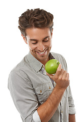 Image showing Apple, healthy diet and happy man with food, nutrition and isolated on a white background in studio. Hungry person eating fresh green fruit, vegan and wellness benefits, vitamin c or organic detox