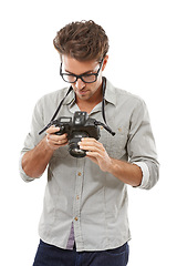 Image showing Man, camera and photographer in studio for lens adjust or creative vision, capture hobby or white background. Male person, digital equipment and picture art on mockup space, professional or skill