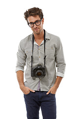 Image showing Portrait, confident man and photographer with camera on neck in studio isolated on a white background in Spain. Person in glasses, creative paparazzi and fashion style of model with hands in pocket