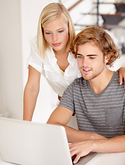 Image showing Laptop, smile and research with a young couple in their apartment for planning or ecommerce together. Computer, bank or wealth management with a happy man and woman in their home for money growth
