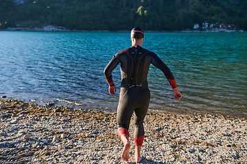 Image showing Triathlon athlete starting swimming training on lake