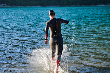 Image showing Triathlon athlete starting swimming training on lake