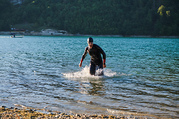 Image showing Triathlon athlete starting swimming training on lake