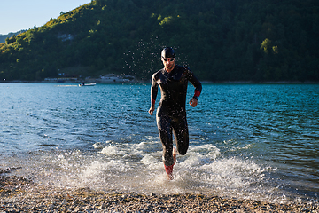 Image showing Triathlon athlete starting swimming training on lake