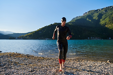 Image showing Triathlon athlete starting swimming training on lake