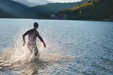 Image showing Triathlon athlete starting swimming training on lake