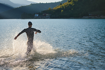 Image showing Triathlon athlete starting swimming training on lake