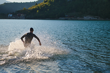 Image showing Triathlon athlete starting swimming training on lake