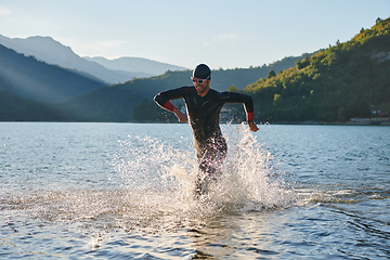 Image showing Triathlon athlete starting swimming training on lake