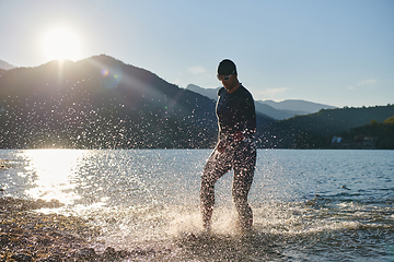 Image showing Triathlon athlete starting swimming training on lake