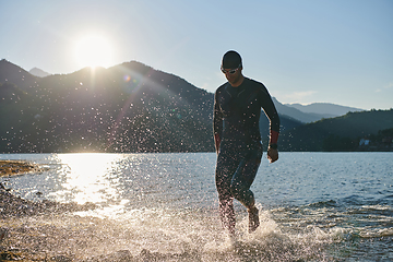 Image showing Triathlon athlete starting swimming training on lake