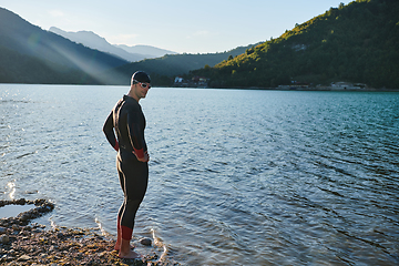 Image showing Triathlon athlete starting swimming training on lake