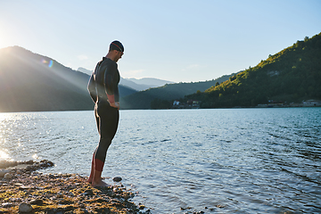 Image showing Triathlon athlete starting swimming training on lake