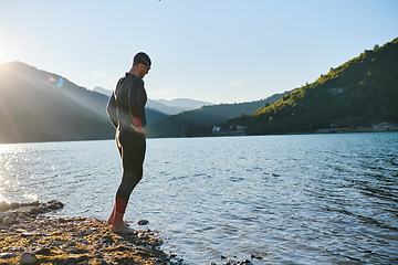 Image showing Triathlon athlete starting swimming training on lake