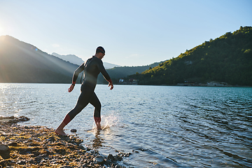 Image showing Triathlon athlete starting swimming training on lake